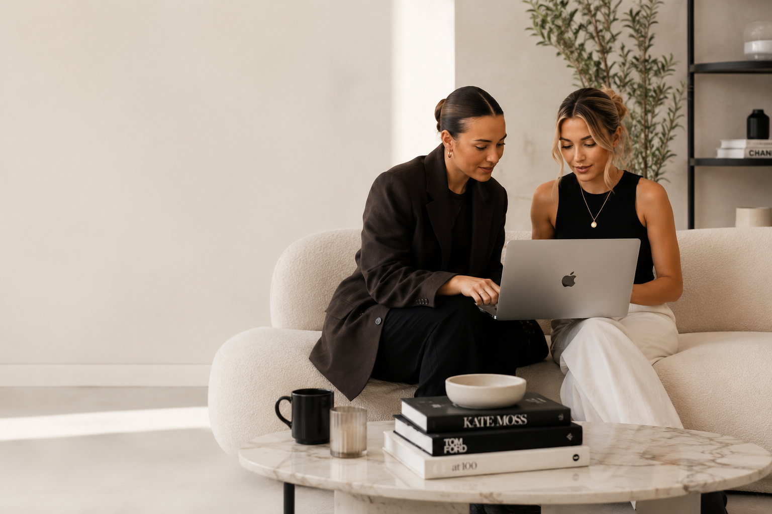 Two creators reviewing a campaign together on a laptop
